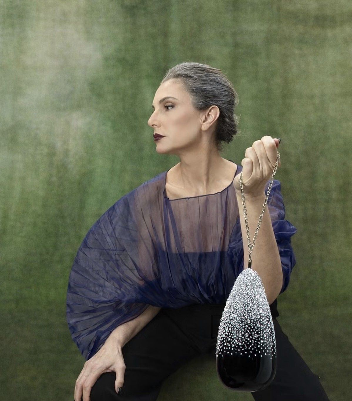 Muse holding the crystal teardrop bag