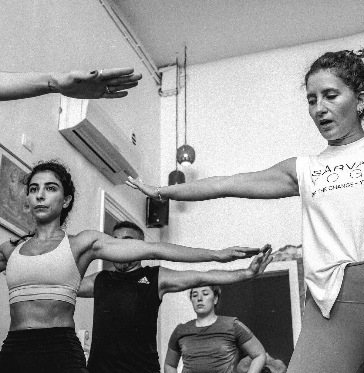 Black and white class in warrior pose