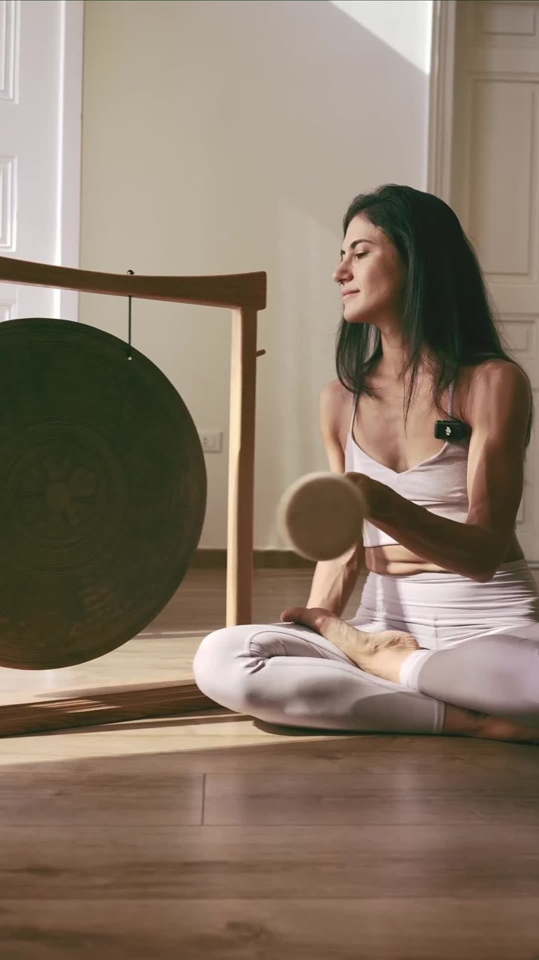 Teacher film still, playing the gong